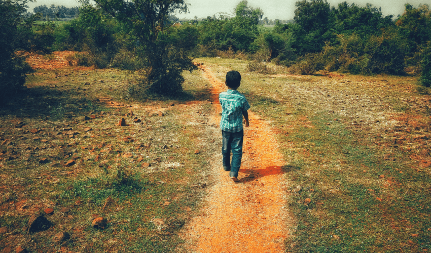 Child walking down dirt path